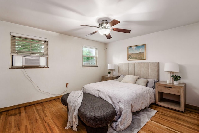 1775 NW Ct Unit 109, Columbus, OH 43212 - bedroom with baseboards, wood finished floors, cooling unit, and ceiling fan