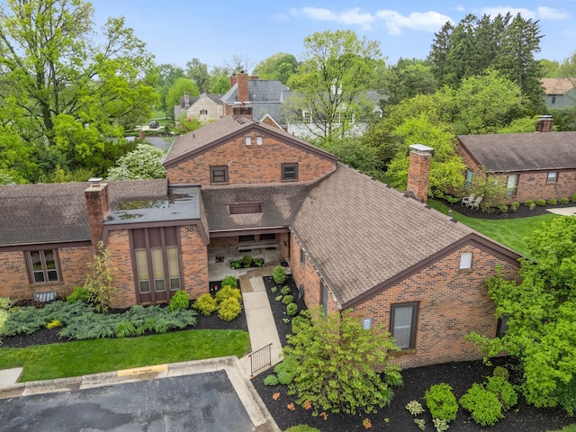 4216 Chaucer Ln, Columbus, OH 43220 - view of front of property with a chimney, brick siding, and uncovered parking