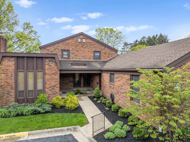 4216 Chaucer Ln, Columbus, OH 43220 - view of front of property with brick siding, a gate, a chimney, and roof with shingles