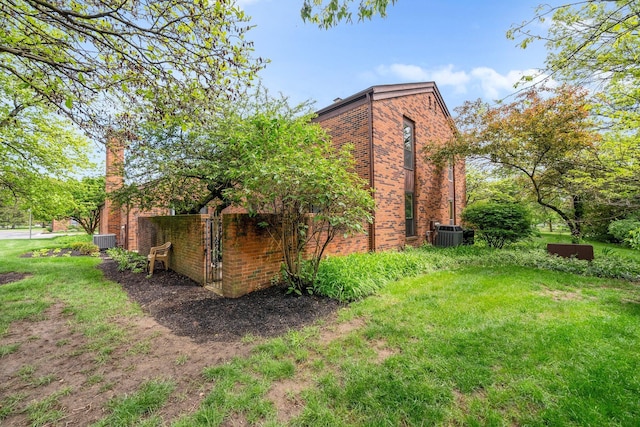 4216 Chaucer Ln, Columbus, OH 43220 - view of side of home with a chimney, cooling unit, and brick siding