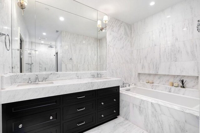 250 W Spring St Unit 1114, Columbus, OH 43215 - full bath featuring a marble finish shower, double vanity, tile walls, a garden tub, and recessed lighting