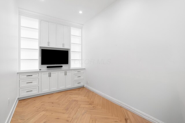 250 W Spring St Unit 1114, Columbus, OH 43215 - unfurnished living room with baseboards, recessed lighting, and built in shelves