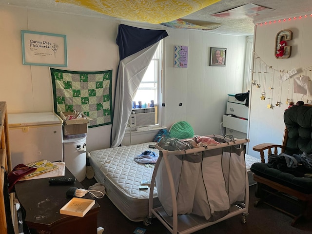 bedroom featuring cooling unit and a textured ceiling
