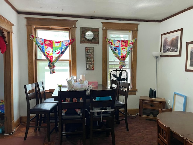 dining space with ornamental molding