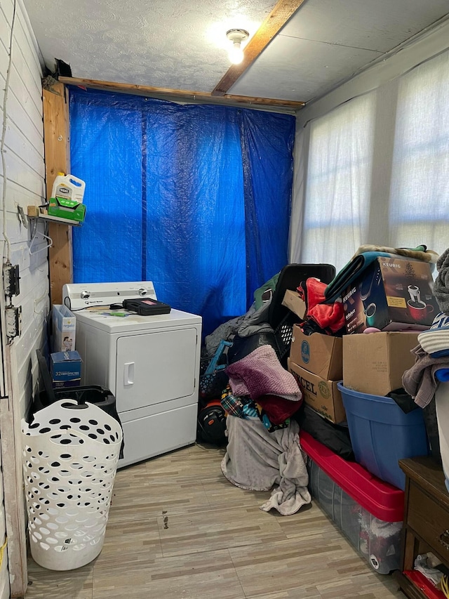 laundry area featuring a wealth of natural light, washer / clothes dryer, laundry area, and wood finished floors