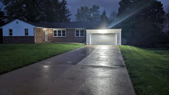 ranch-style house featuring concrete driveway, a garage, a front yard, and brick siding