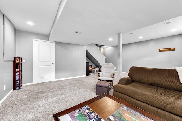carpeted living area featuring baseboards, visible vents, and recessed lighting