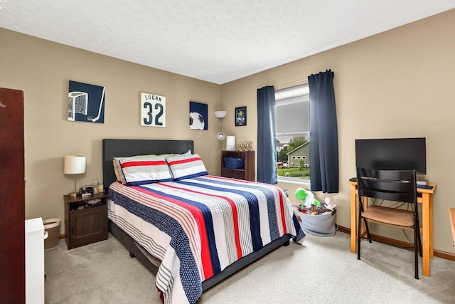 carpeted bedroom featuring a textured ceiling, baseboards, and a wall unit AC