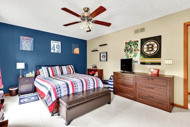 bedroom featuring a ceiling fan, carpet floors, a textured ceiling, visible vents, and baseboards