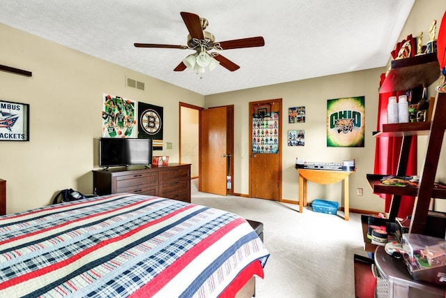 bedroom featuring a textured ceiling, baseboards, ceiling fan, visible vents, and light colored carpet