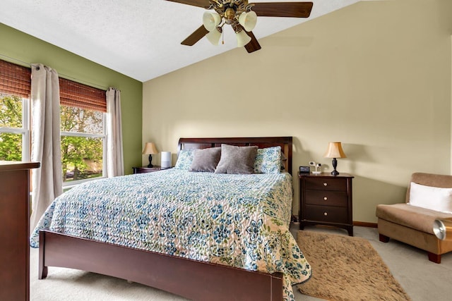 bedroom with lofted ceiling, a ceiling fan, and carpet