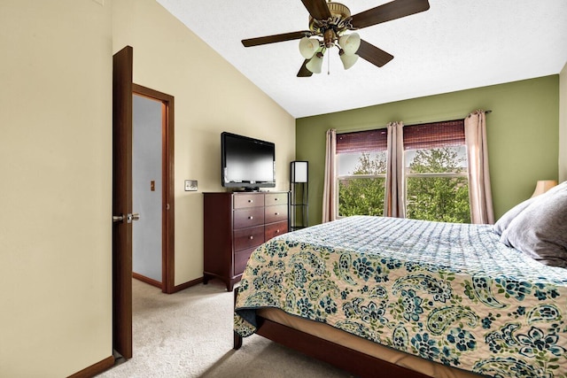 bedroom with light carpet, baseboards, lofted ceiling, and ceiling fan