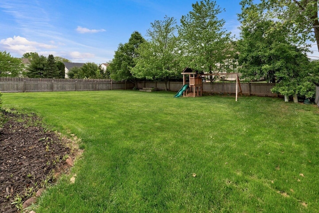 view of yard featuring a playground and a fenced backyard