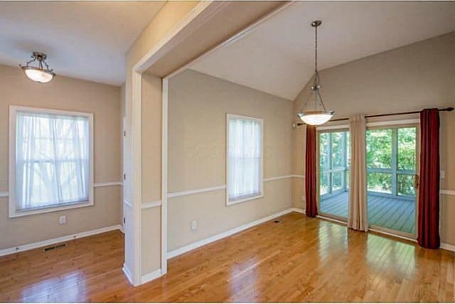 1139 Cross Creeks Rdg, Pickerington, OH 43147 - unfurnished dining area with wood finished floors, healthy amount of natural light, baseboards, and vaulted ceiling