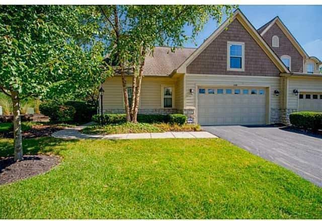 1139 Cross Creeks Rdg, Pickerington, OH 43147 - view of front of house featuring an attached garage, driveway, a front yard, and stone siding