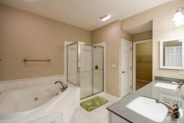 1139 Cross Creeks Rdg, Pickerington, OH 43147 - full bath featuring a shower stall, vanity, a whirlpool tub, a walk in closet, and tile patterned floors