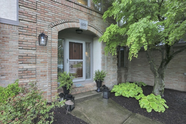 property entrance featuring brick siding