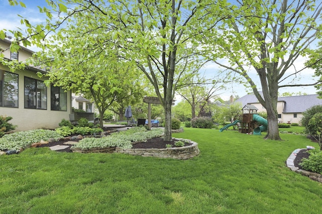 view of grassy yard with a playground