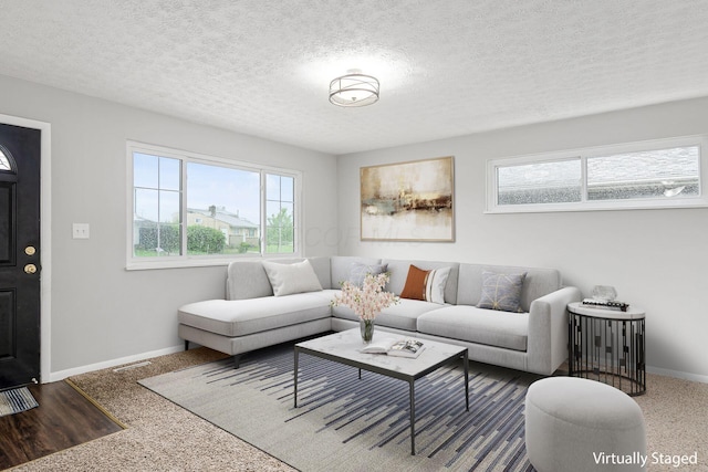 living area featuring a textured ceiling, baseboards, and visible vents