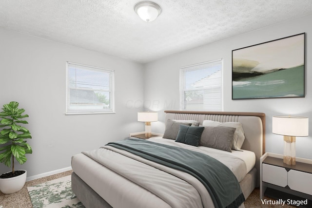 bedroom featuring baseboards, multiple windows, and a textured ceiling