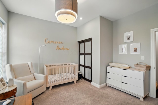931 Dennison Ave, Columbus, OH 43201 - bedroom featuring baseboards, recessed lighting, light carpet, and a nursery area