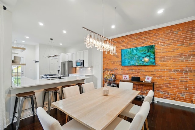931 Dennison Ave, Columbus, OH 43201 - dining area with brick wall, recessed lighting, baseboards, and dark wood finished floors