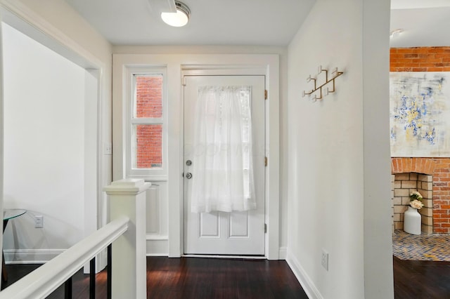 931 Dennison Ave, Columbus, OH 43201 - doorway to outside featuring baseboards and dark wood-type flooring