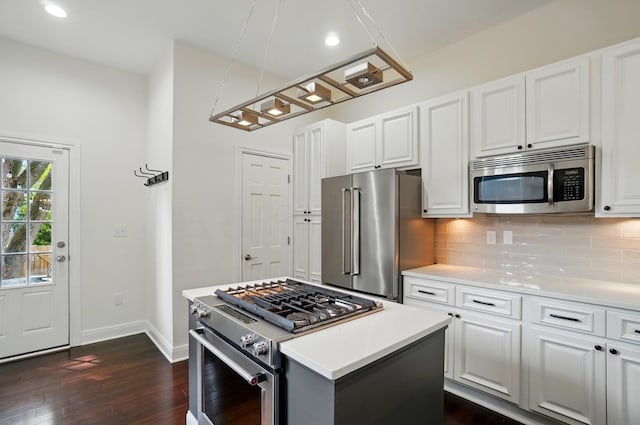 931 Dennison Ave, Columbus, OH 43201 - kitchen with stainless steel appliances, white cabinets, baseboards, tasteful backsplash, and dark wood-style floors