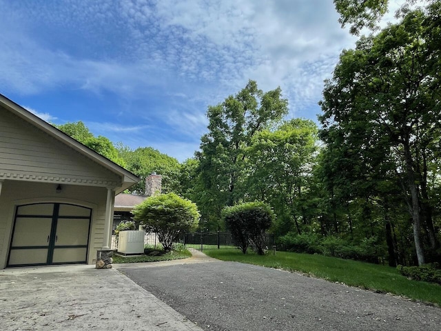 61 Wyddfa Ct, Granville, OH 43023 - view of property exterior with asphalt driveway and a chimney