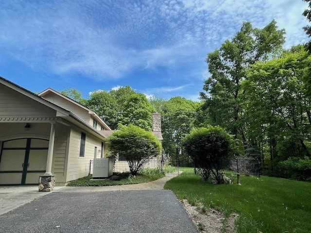 61 Wyddfa Ct, Granville, OH 43023 - view of side of home featuring concrete driveway, cooling unit, and a garage