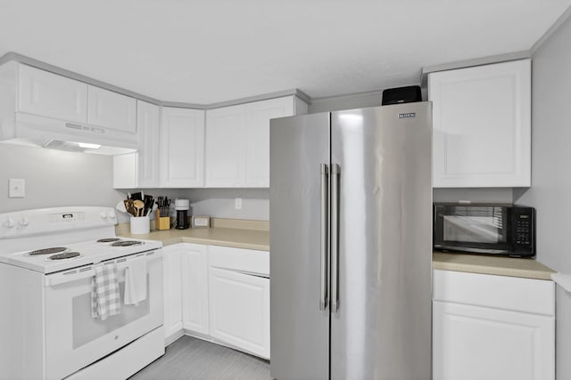 kitchen with freestanding refrigerator, under cabinet range hood, white electric range, white cabinetry, and black microwave
