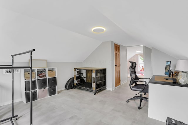 office space featuring vaulted ceiling and baseboards