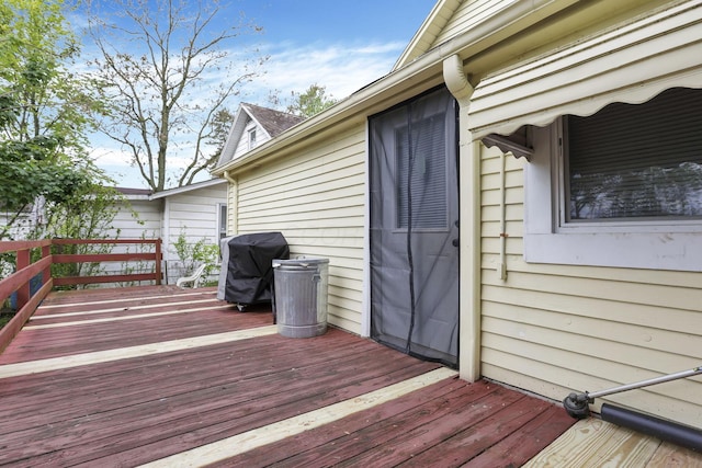 wooden terrace featuring area for grilling