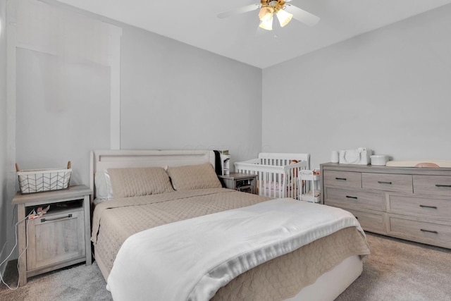 bedroom featuring ceiling fan and light carpet