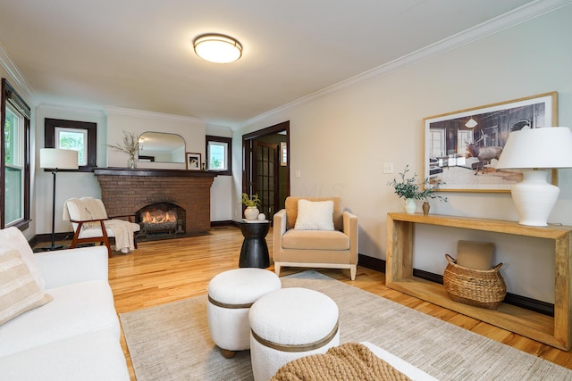24 Brighton Rd, Columbus, OH 43202 - living area with ornamental molding, wood finished floors, a brick fireplace, and baseboards