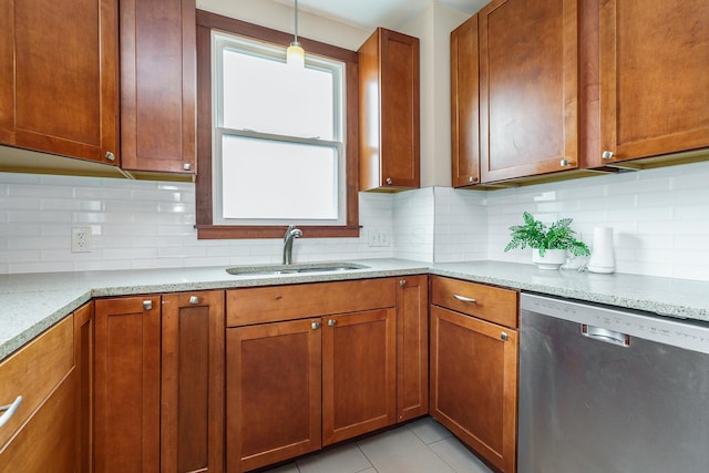 24 Brighton Rd, Columbus, OH 43202 - kitchen with dishwasher, a sink, brown cabinetry, and decorative backsplash