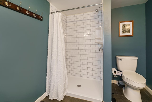 24 Brighton Rd, Columbus, OH 43202 - bathroom with a shower stall, toilet, baseboards, and tile patterned flooring