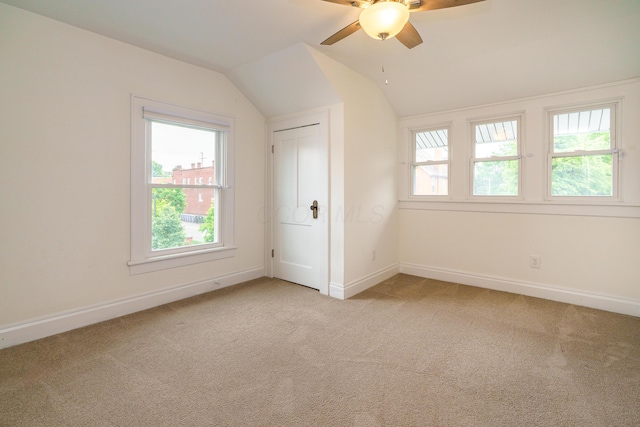 24 Brighton Rd, Columbus, OH 43202 - unfurnished bedroom featuring light carpet, baseboards, lofted ceiling, and a ceiling fan