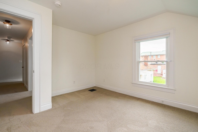 24 Brighton Rd, Columbus, OH 43202 - unfurnished bedroom with light colored carpet, baseboards, and lofted ceiling