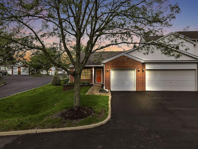 6010 Acropolis Way, Columbus, OH 43231 - view of front of property with driveway, an attached garage, brick siding, and a lawn