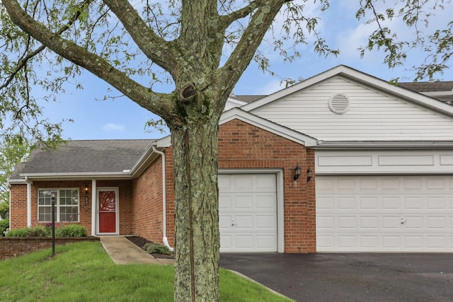 6010 Acropolis Way, Columbus, OH 43231 - single story home featuring asphalt driveway, brick siding, an attached garage, a shingled roof, and a front yard