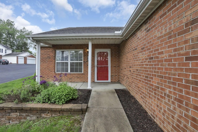 6010 Acropolis Way, Columbus, OH 43231 - view of exterior entry with brick siding, roof with shingles, and covered porch