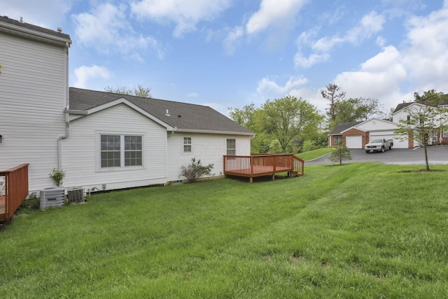 6010 Acropolis Way, Columbus, OH 43231 - back of house featuring a deck, a yard, a shingled roof, central AC unit, and a detached garage