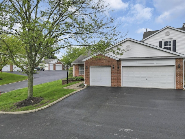 6010 Acropolis Way, Columbus, OH 43231 - traditional-style house featuring driveway, brick siding, an attached garage, and a front yard