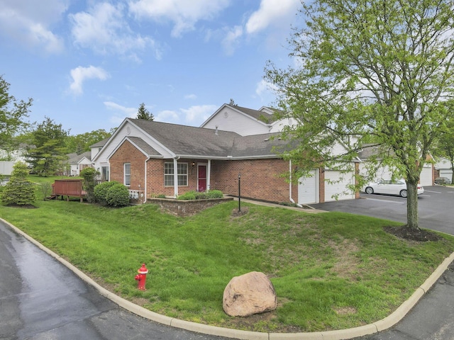 6010 Acropolis Way, Columbus, OH 43231 - view of front of home with brick siding, asphalt driveway, a front yard, and a shingled roof