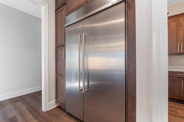1473 Dogwood Loop, Powell, OH 43065 - detailed view of stainless steel built in fridge, wood finished floors, and baseboards
