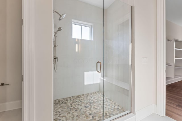 1473 Dogwood Loop, Powell, OH 43065 - bathroom featuring a stall shower and a walk in closet