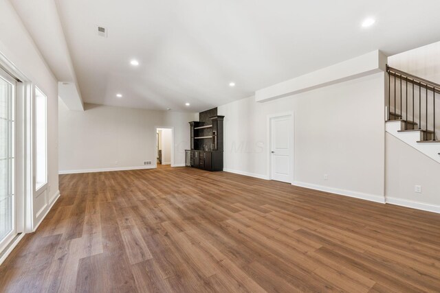 1473 Dogwood Loop, Powell, OH 43065 - unfurnished living room featuring wood finished floors, stairway, baseboards, and recessed lighting