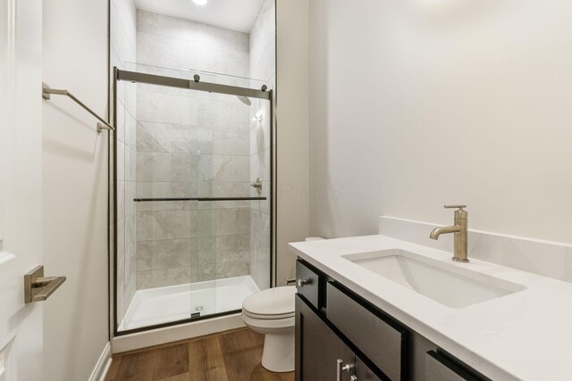1473 Dogwood Loop, Powell, OH 43065 - full bathroom with toilet, a shower stall, wood finished floors, and vanity