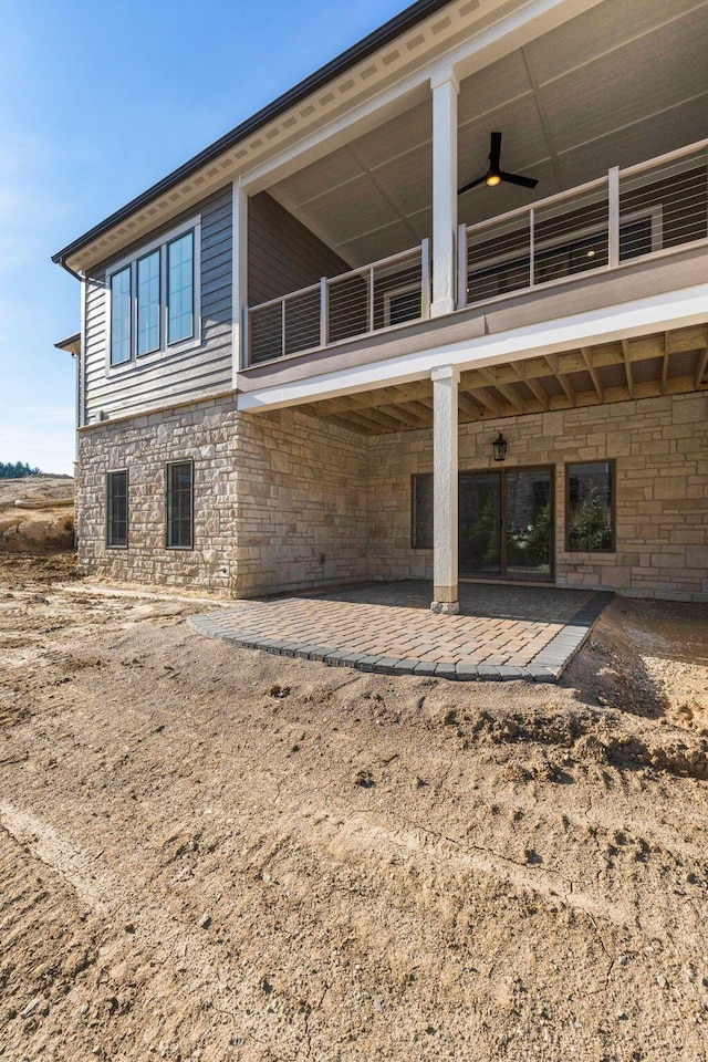 1473 Dogwood Loop, Powell, OH 43065 - back of property with a balcony, a patio area, and stone siding